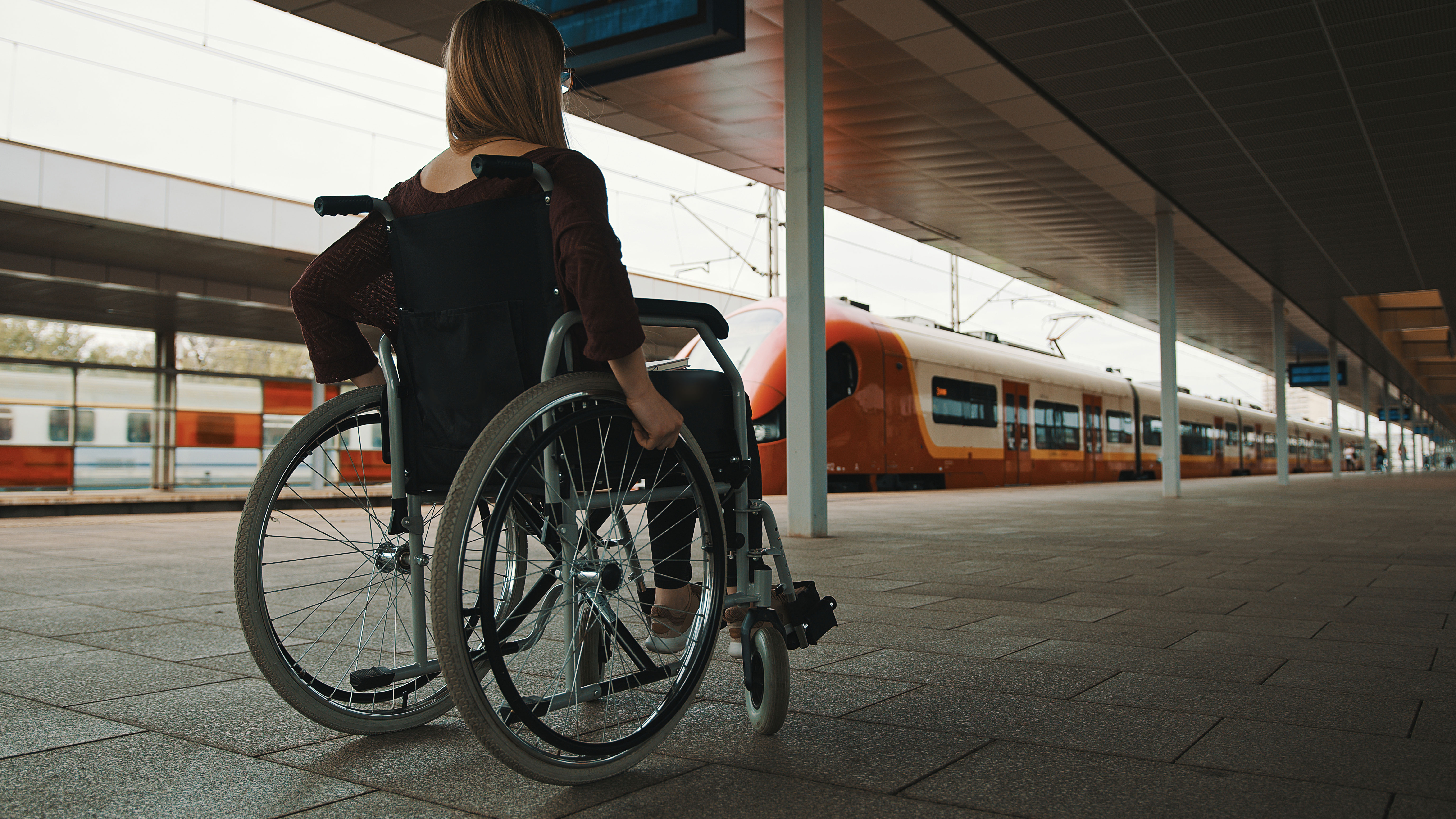 Disabled women waiting for train in wheelchair