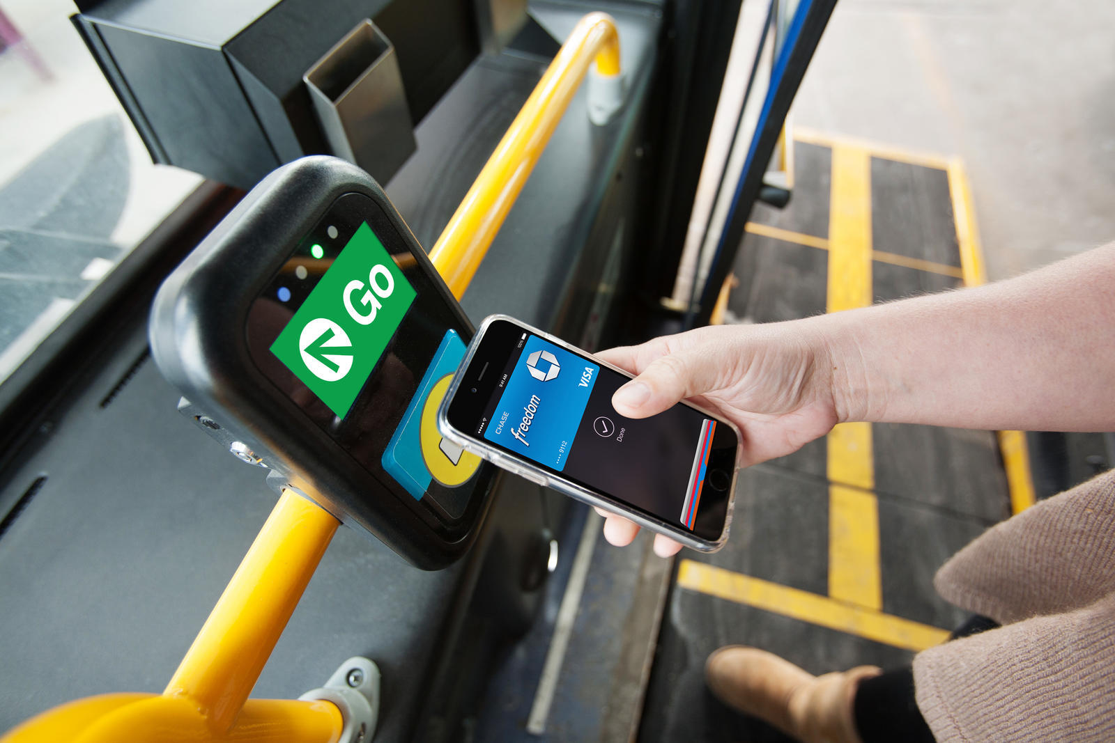 Hand Tapping Apple Pay on Cubic's Ventra Contactless Payment System