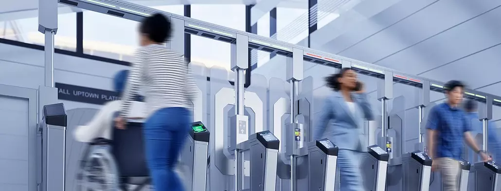 People walking through Cubic's FEnX Fare gate